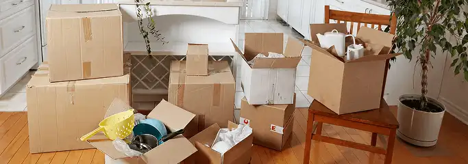 Packed moving boxes and household items in a kitchen before move-out or move-in cleaning, Ann Arbor, MI.